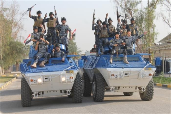  Federal Police raises Iraqi flag over city hall and police station of Shura area