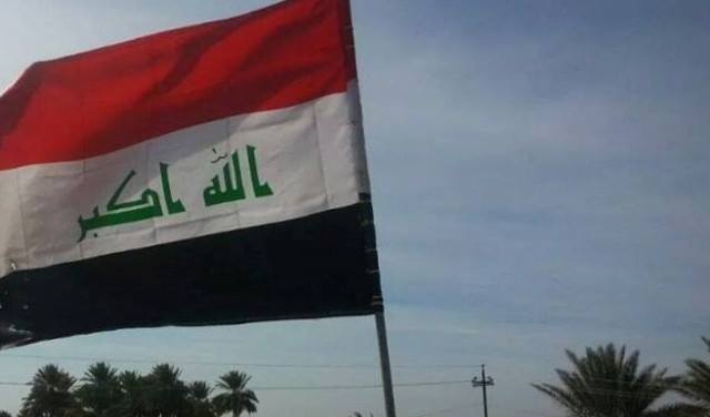  Unidentified men raise Iraqi flag in central Mosul