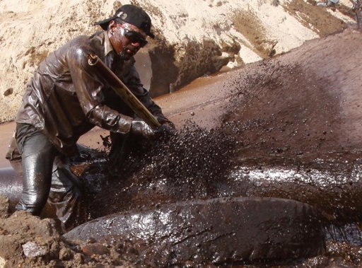  A worker repairs an oil pipeline at Rumaila oil fields, near the southern city of Basra, Iraq, Sunday, Oct. 9, 2011.