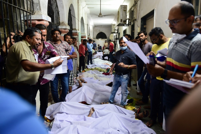  Families line up to bury dead from India bridge collapse