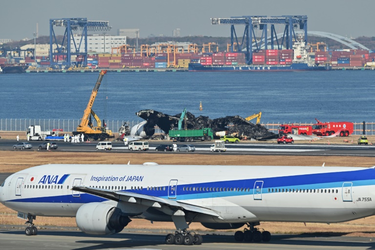  Plane wreckage being cleared from Tokyo airport after collision